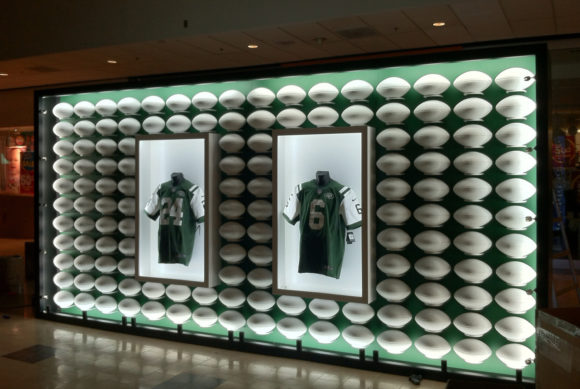 New Jersey Jets display with green and white footballs on wall Jets 6 Jets 24 for champs